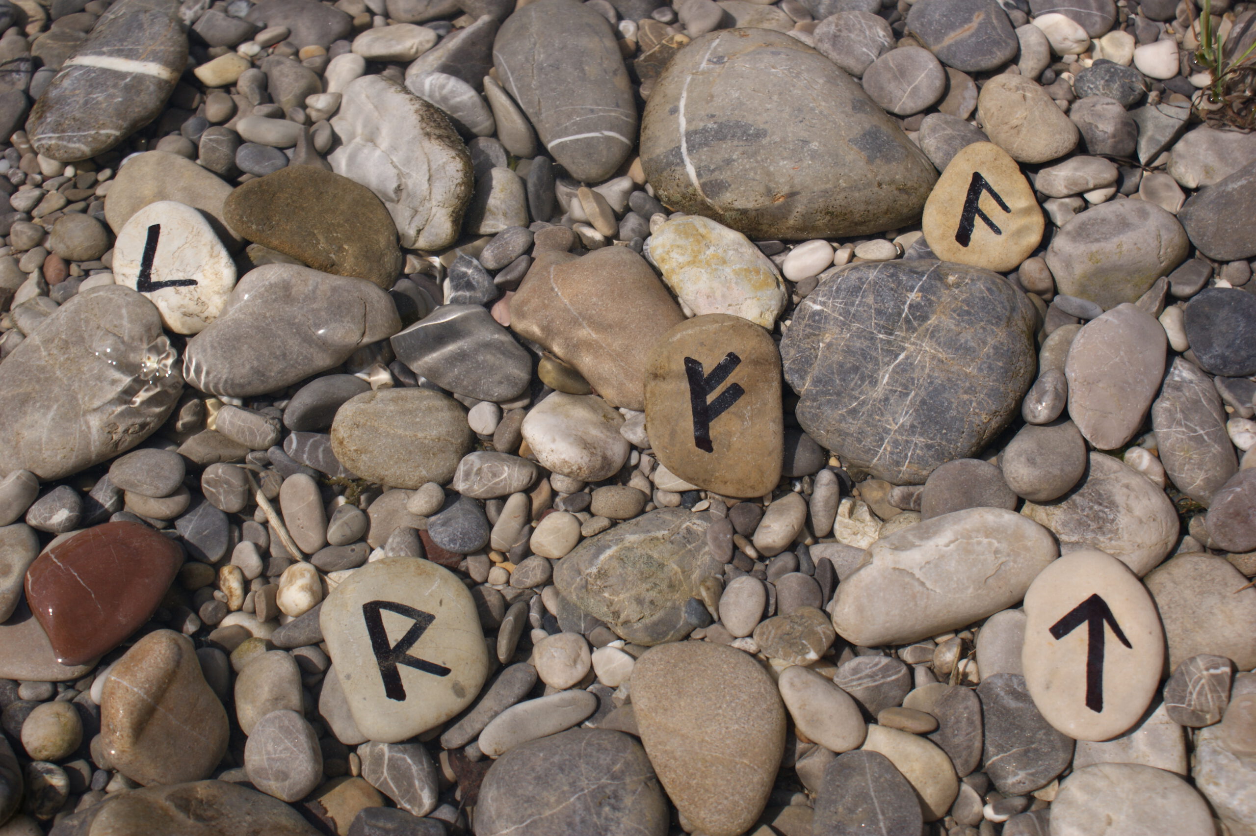 Einige kleine und größere Steine mit Buchstaben darauf